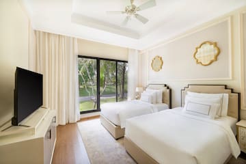 a room with two beds and a television