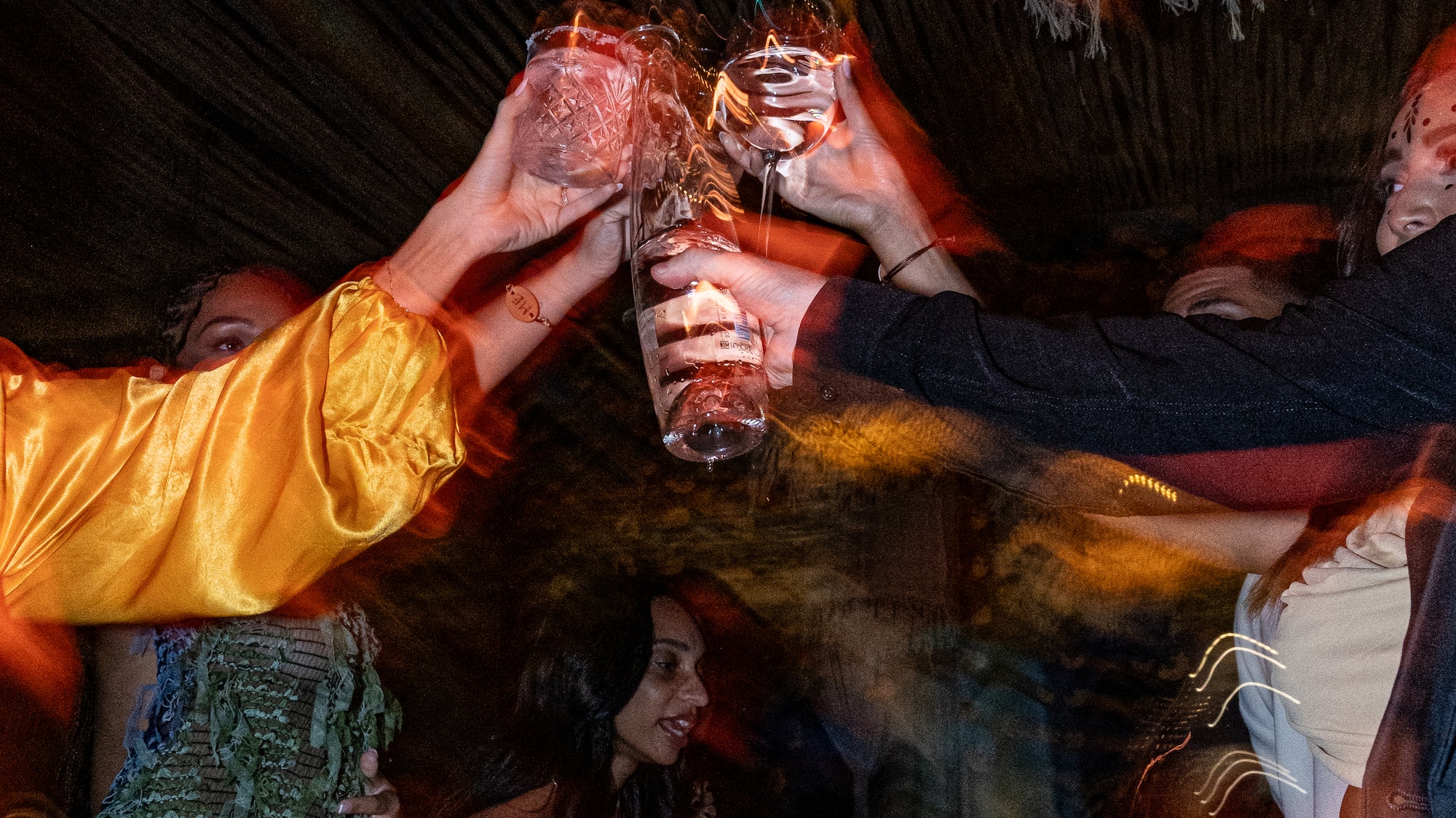 a group of people clinking glasses at a party
