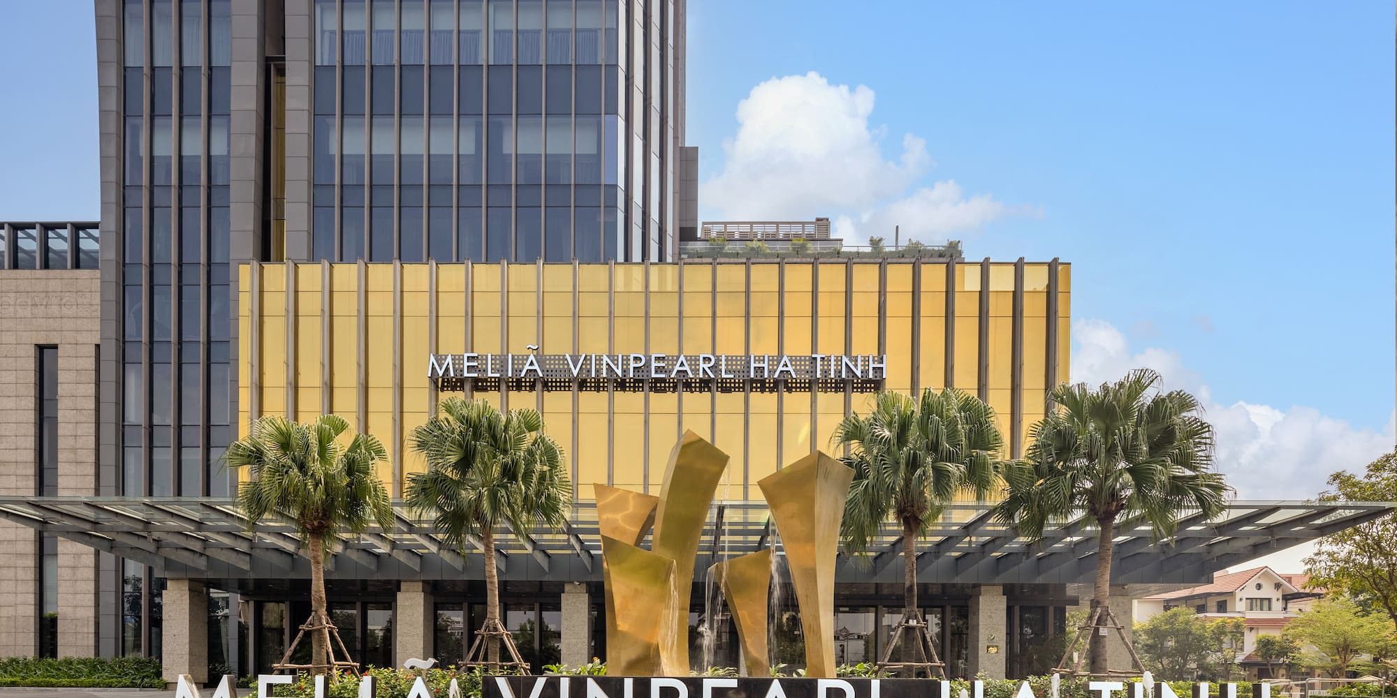 a building with palm trees and a fountain