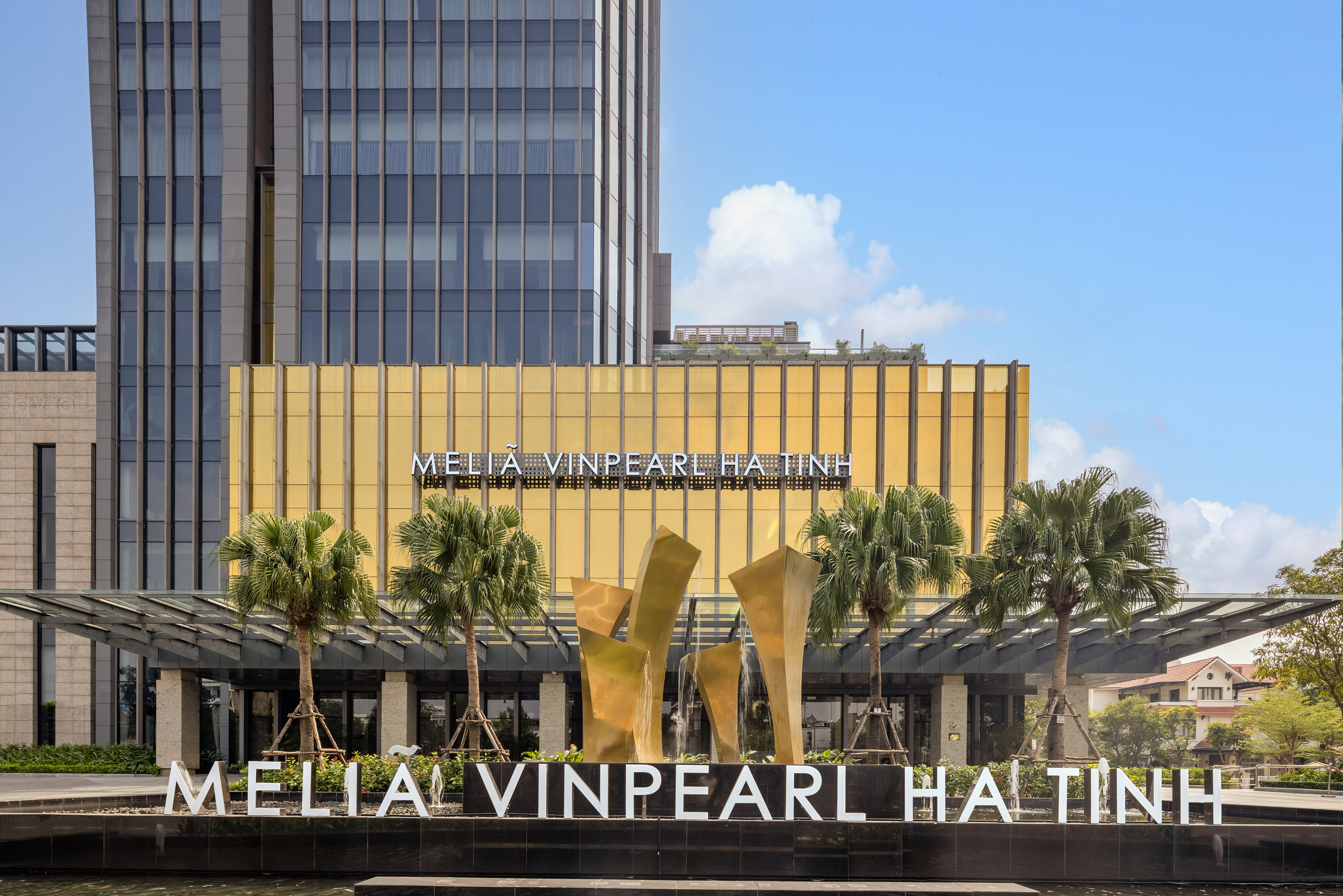 a building with palm trees and a fountain