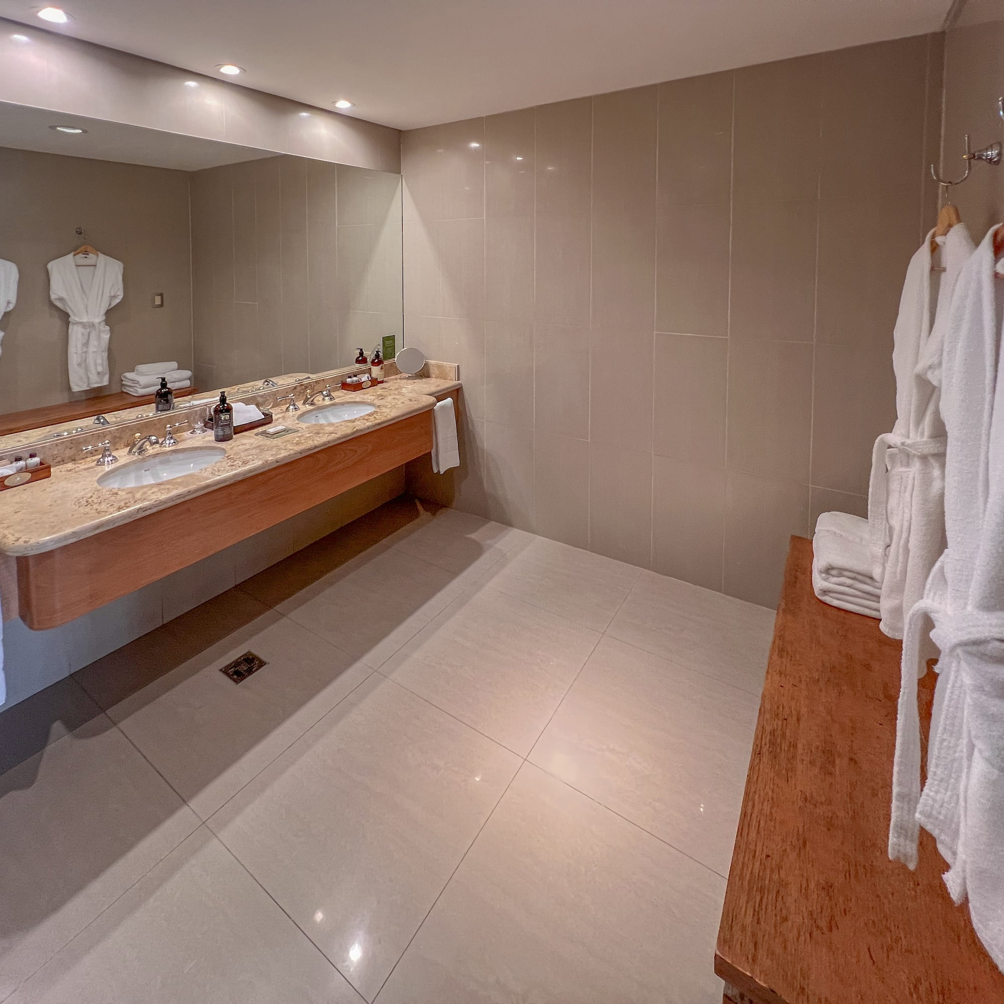 a bathroom with a large mirror and two sinks