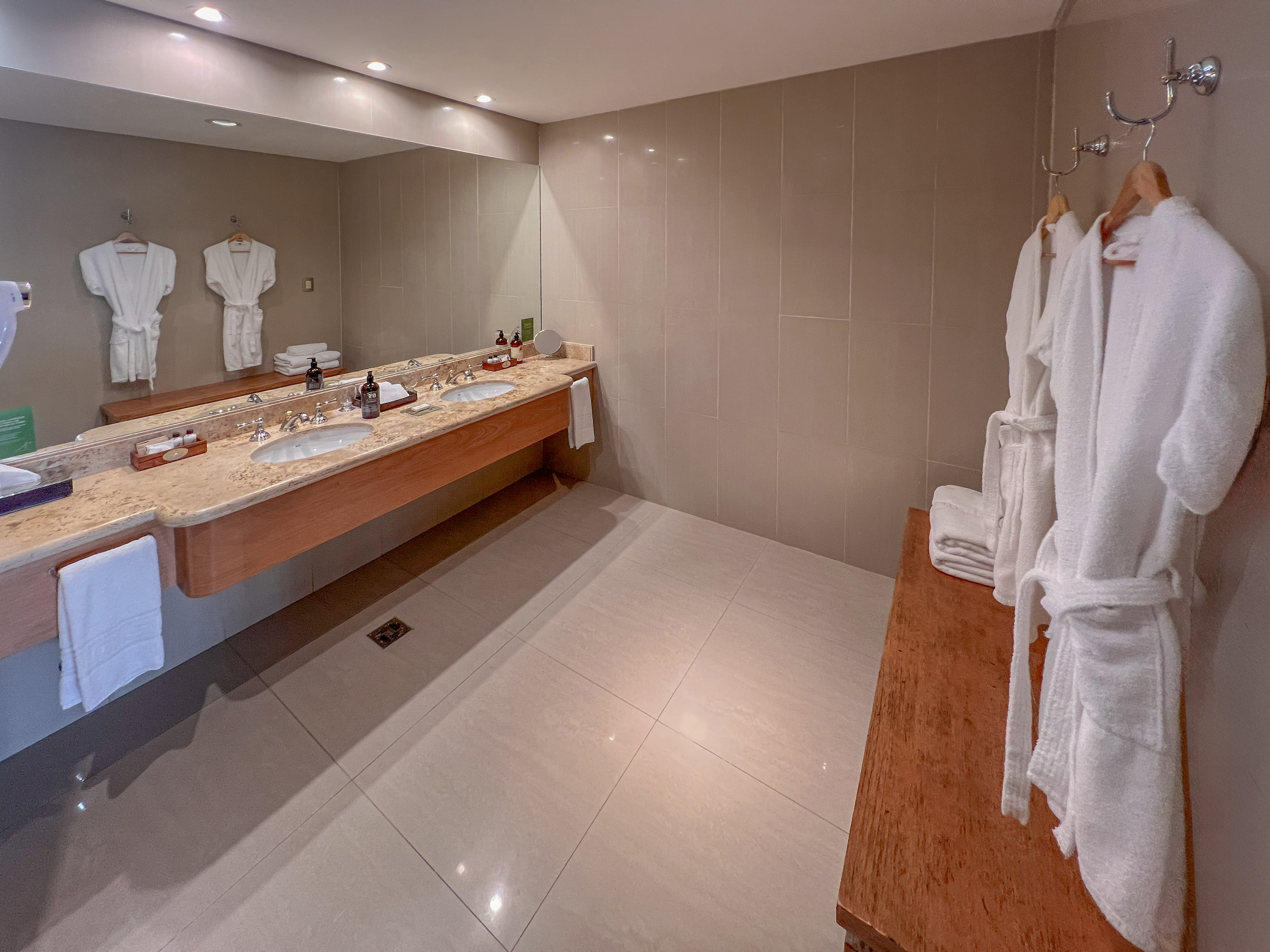 a bathroom with a large mirror and two sinks
