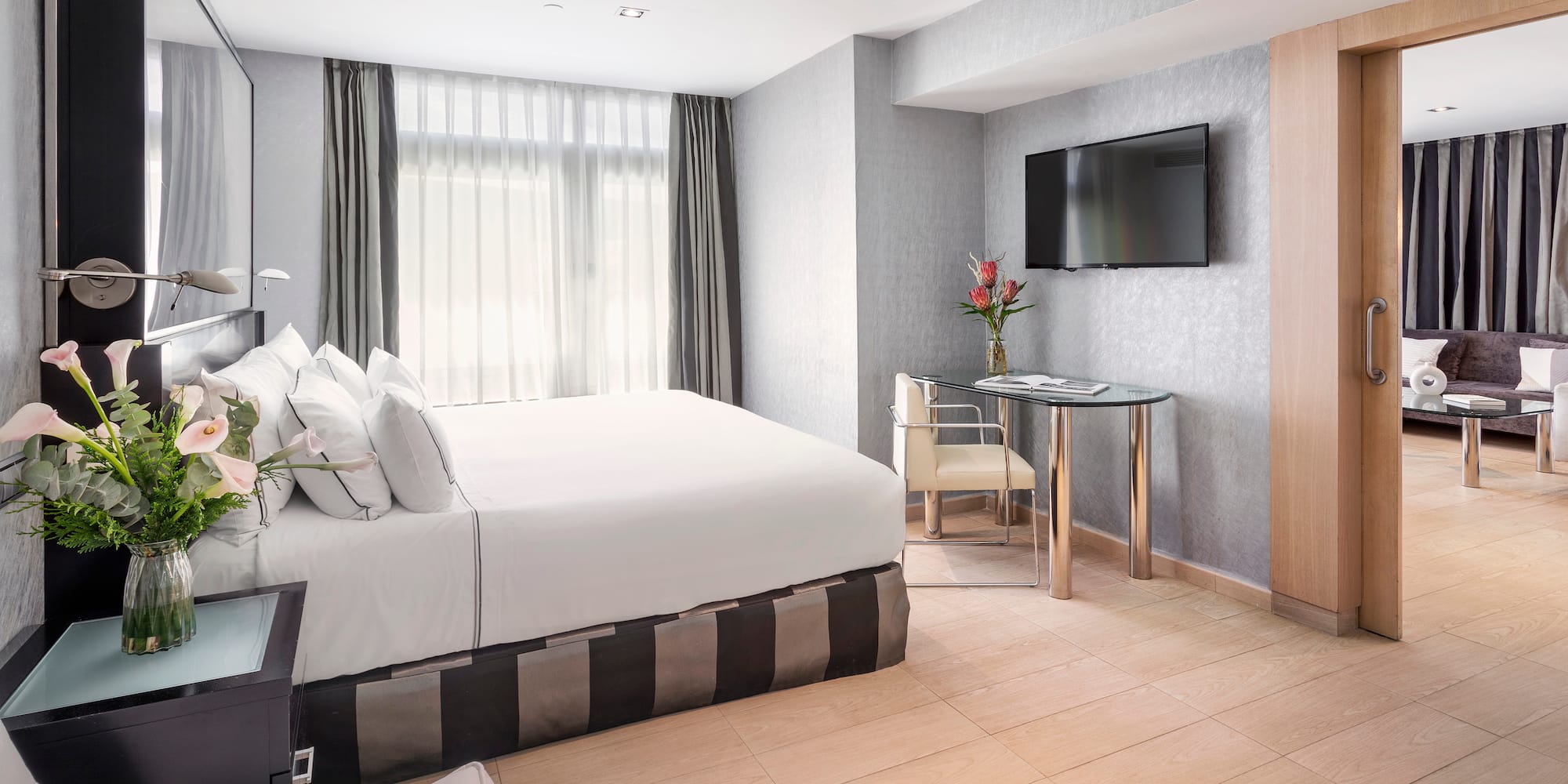 a room with a bed and a television