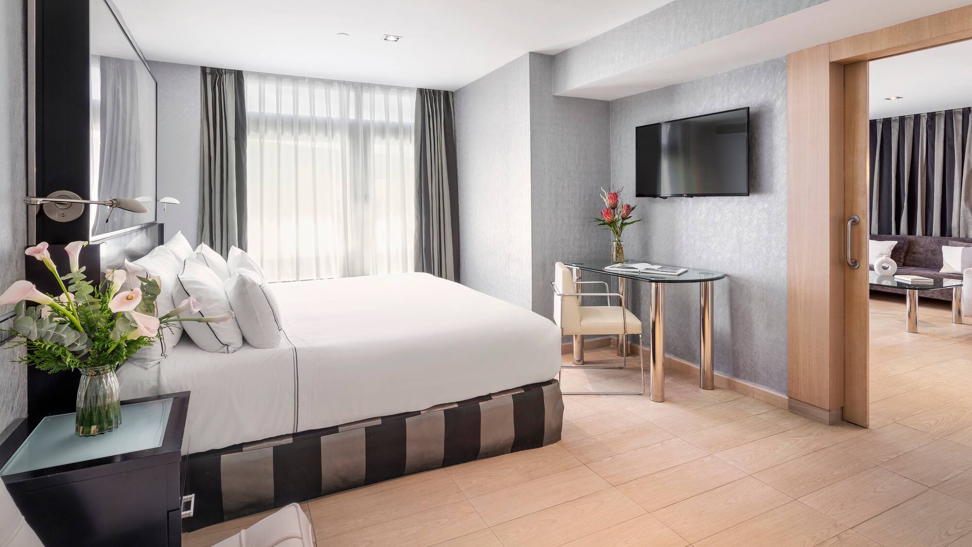 a room with a bed and a television