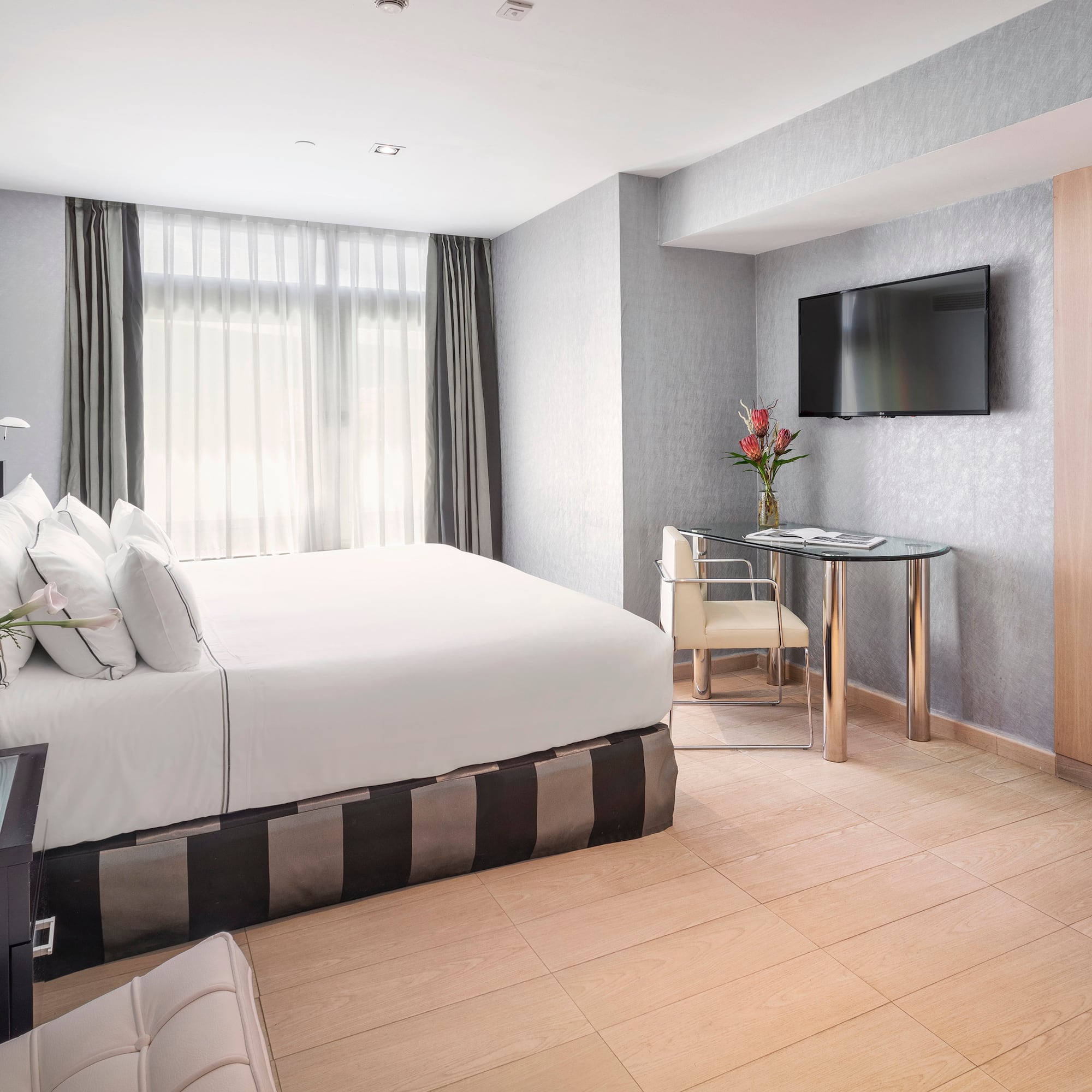 a room with a bed and a television