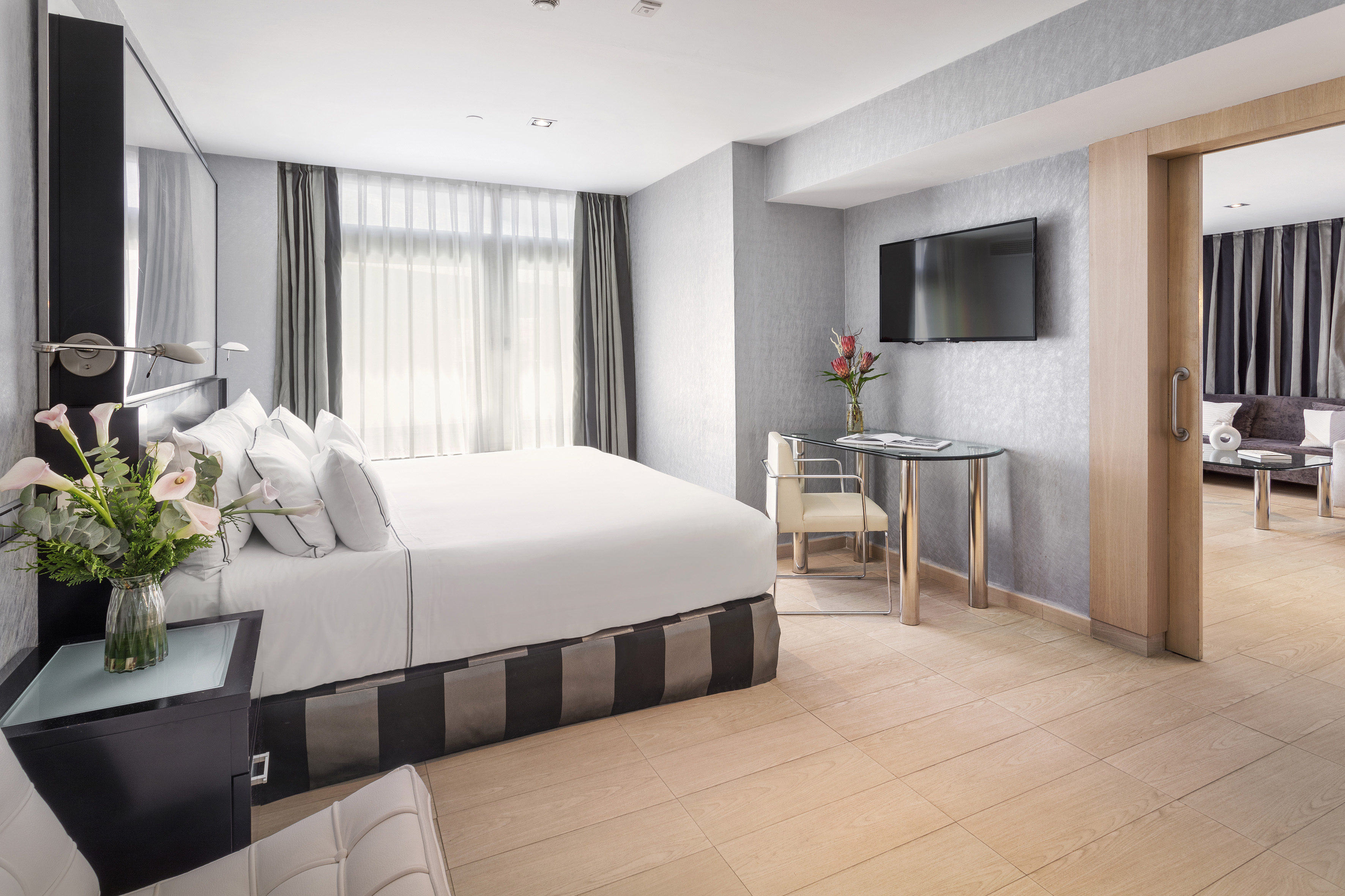 a room with a bed and a television