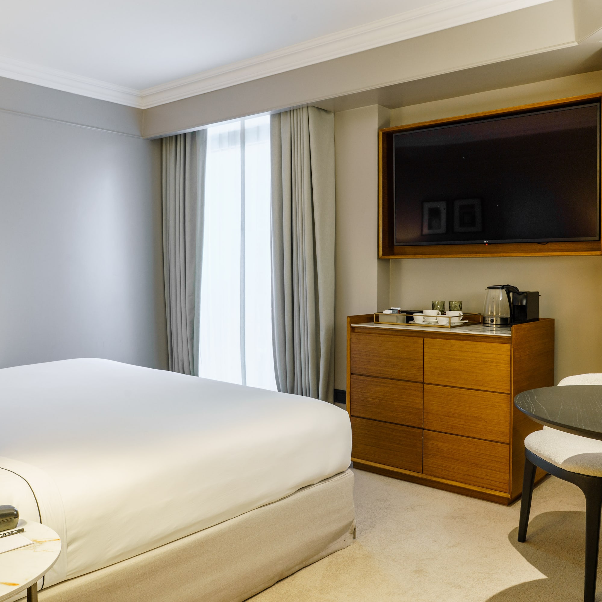 a room with a bed and a television