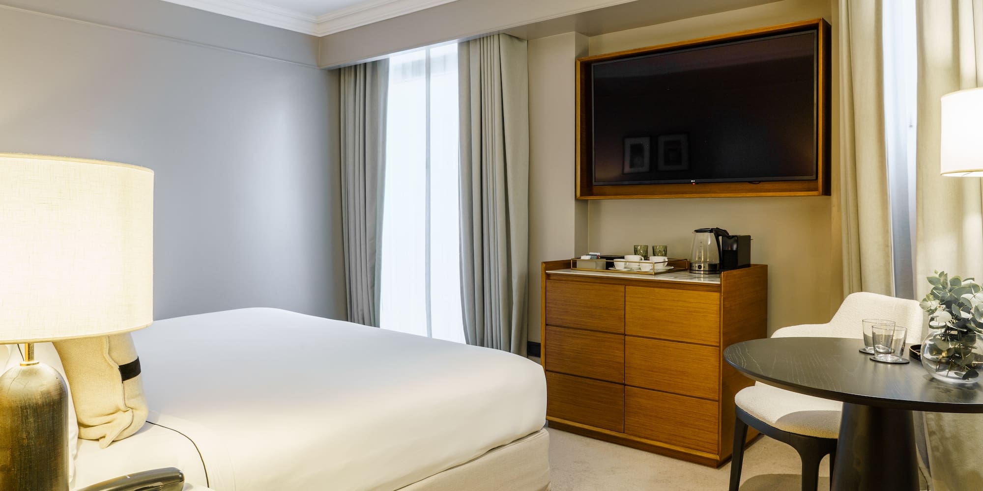 a room with a bed and a television