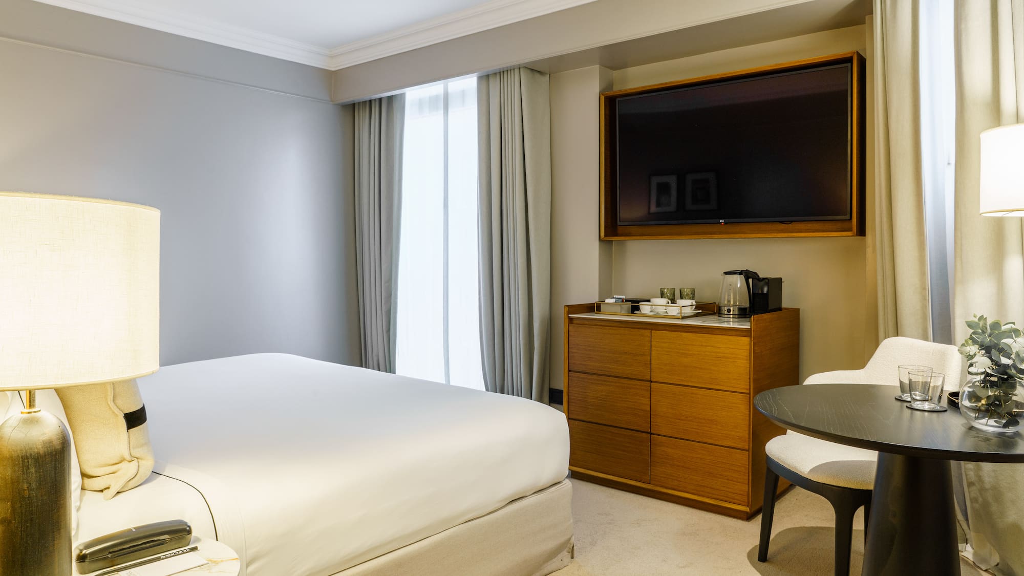 a room with a bed and a television