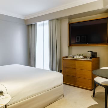 a room with a bed and a television