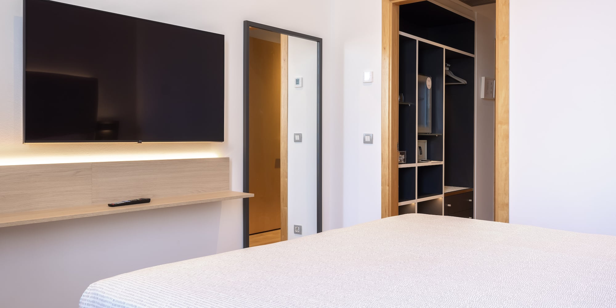 a bedroom with a tv and a bed