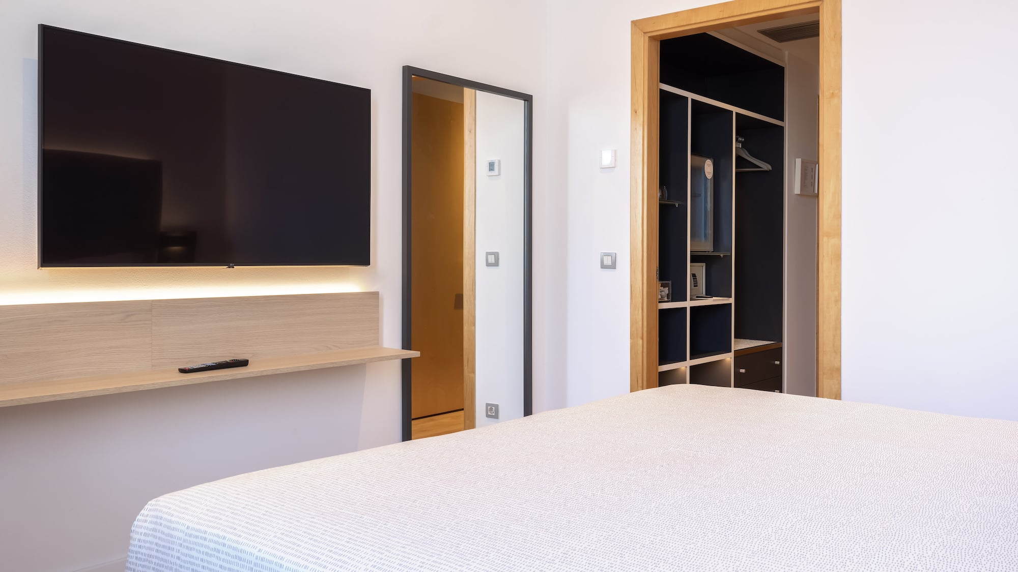 a bedroom with a tv and a bed