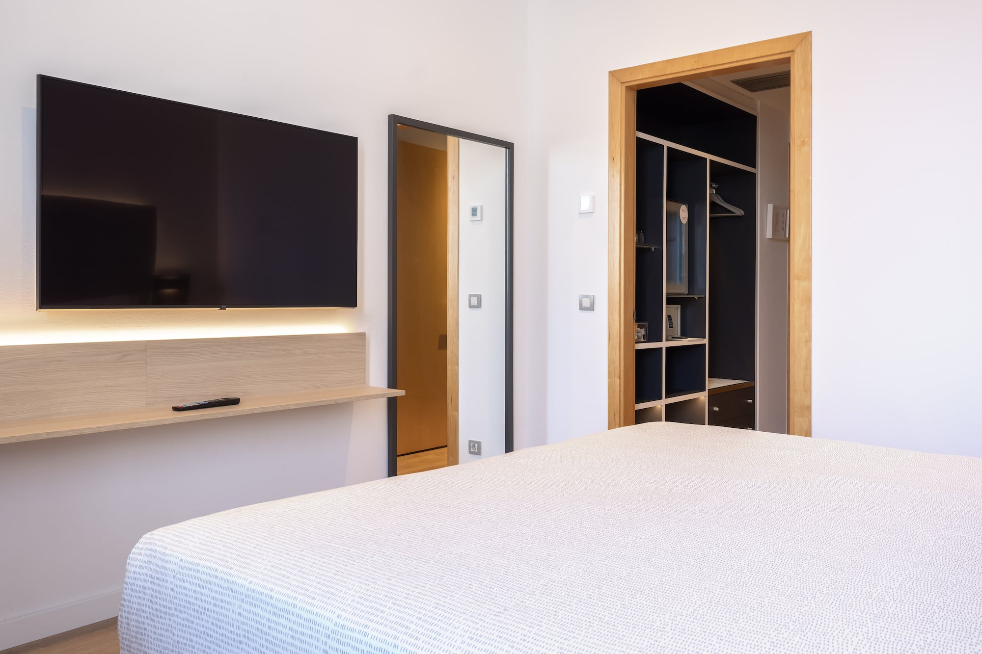 a bedroom with a tv and a bed