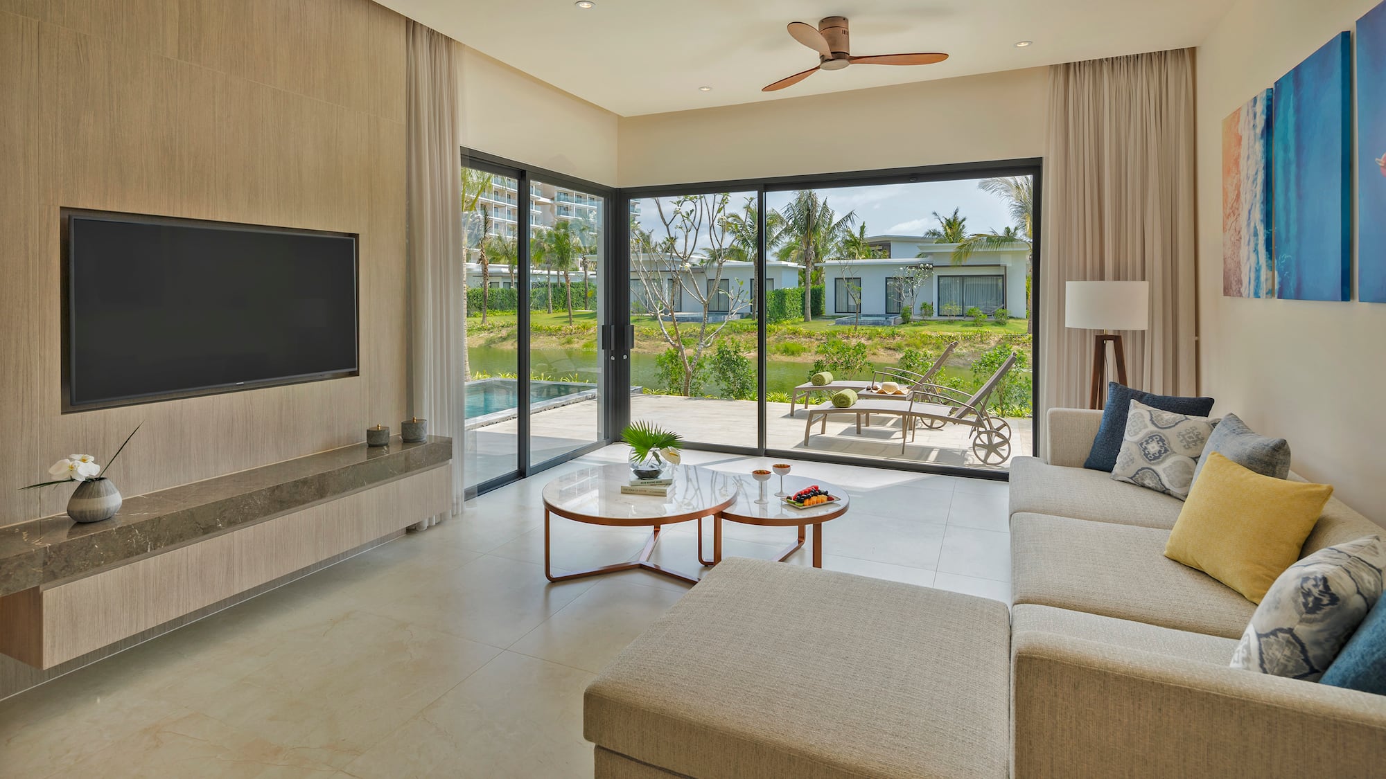 a living room with a large glass door and a television