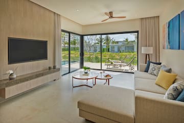 a living room with a large glass door and a television