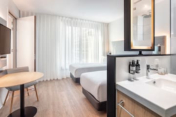 a room with two beds and a mirror