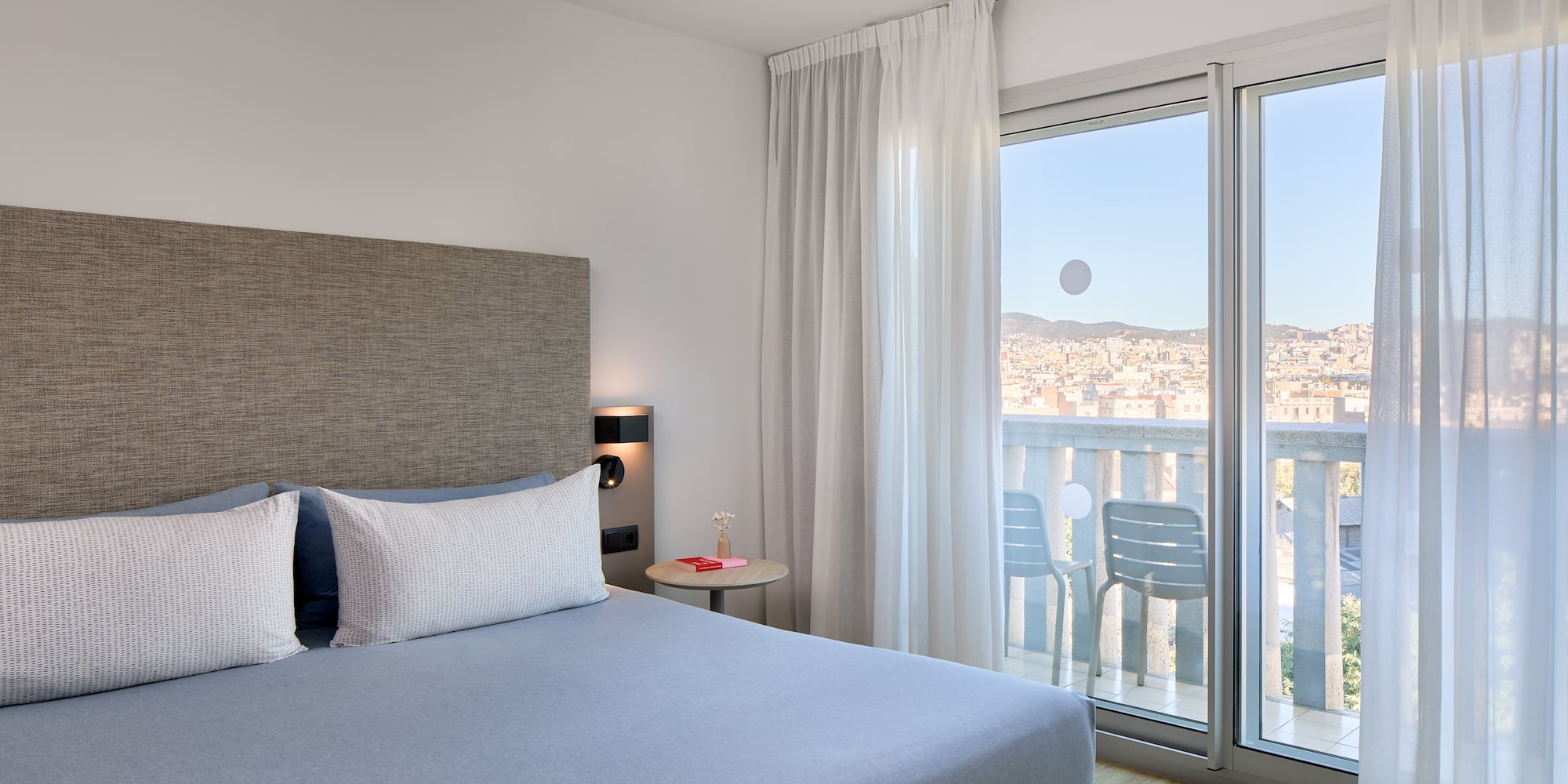 a bedroom with a bed and glass doors