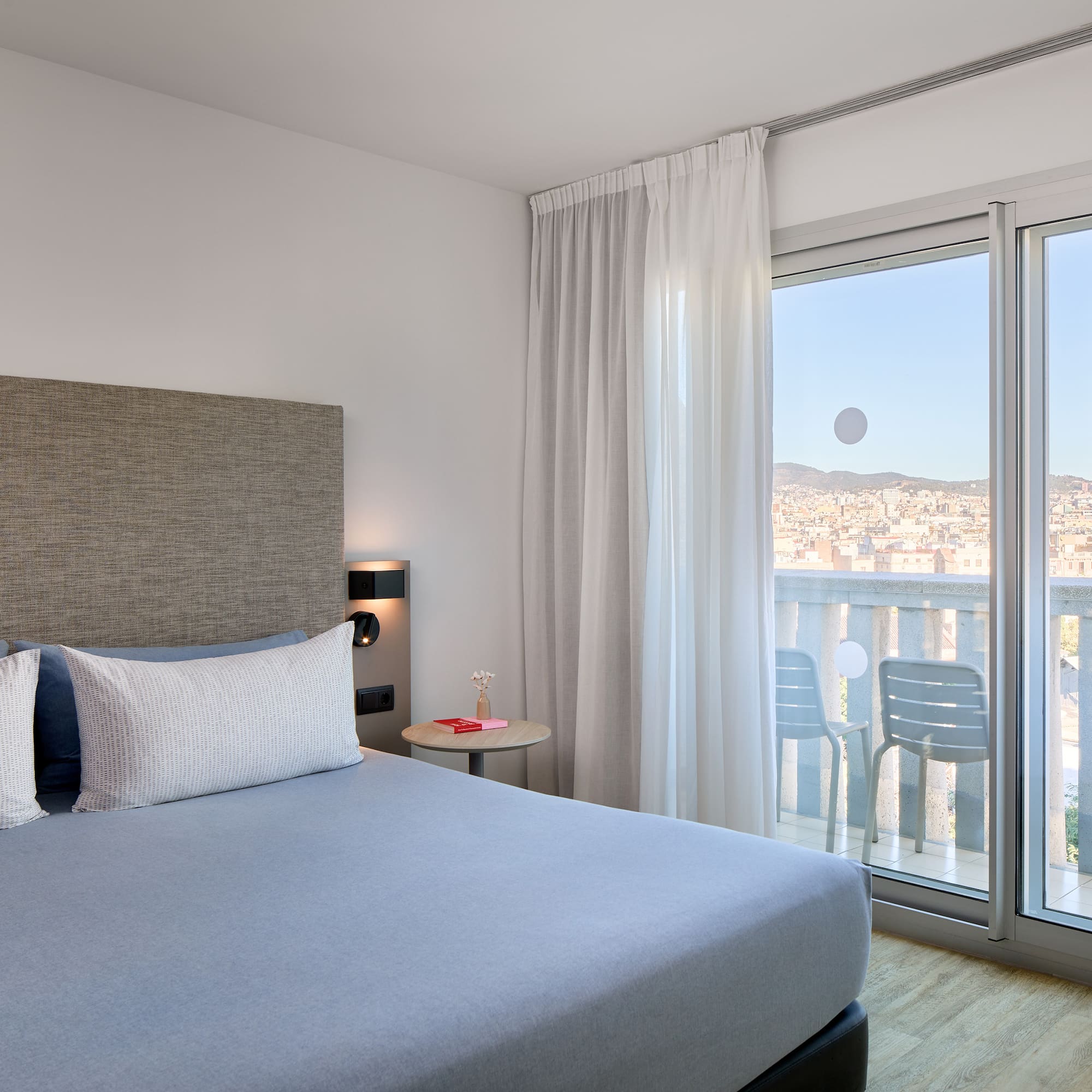 a bedroom with a bed and glass doors