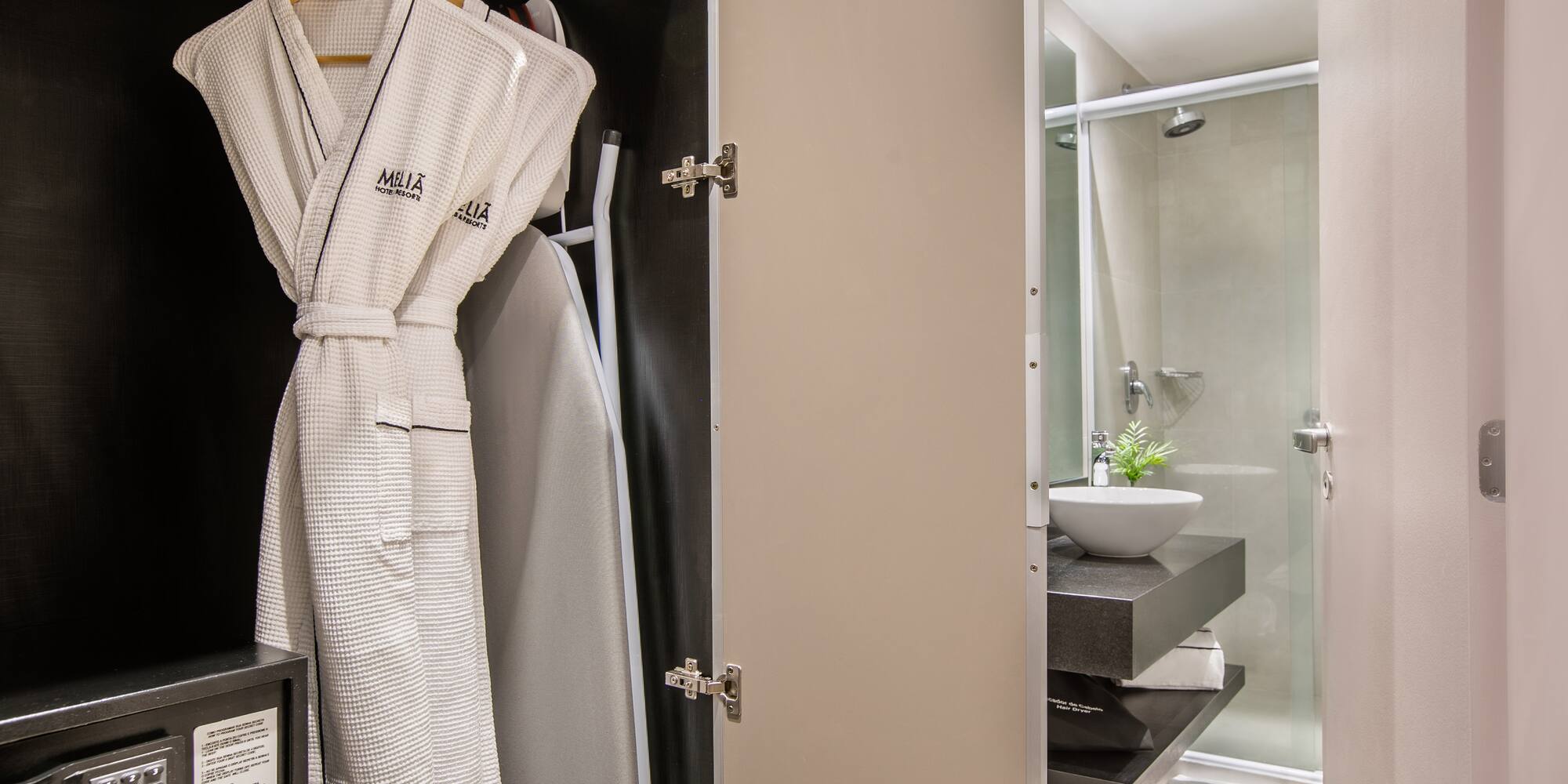 a bathroom with a white robe on a swinger