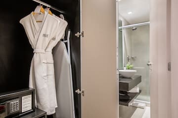 a bathroom with a white robe on a swinger