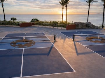 a tennis court with a view of the ocean