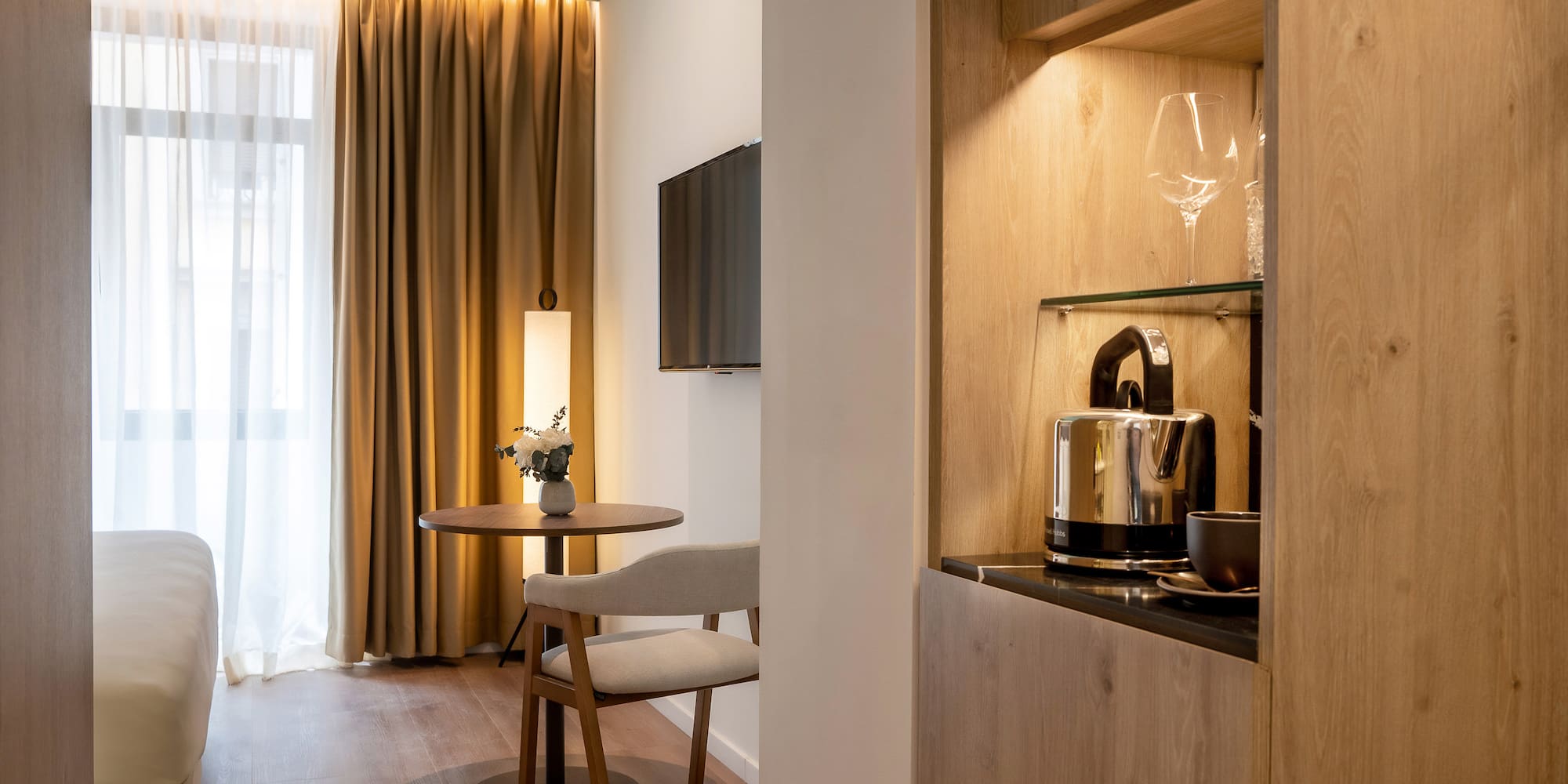 a room with a table and chairs and a television