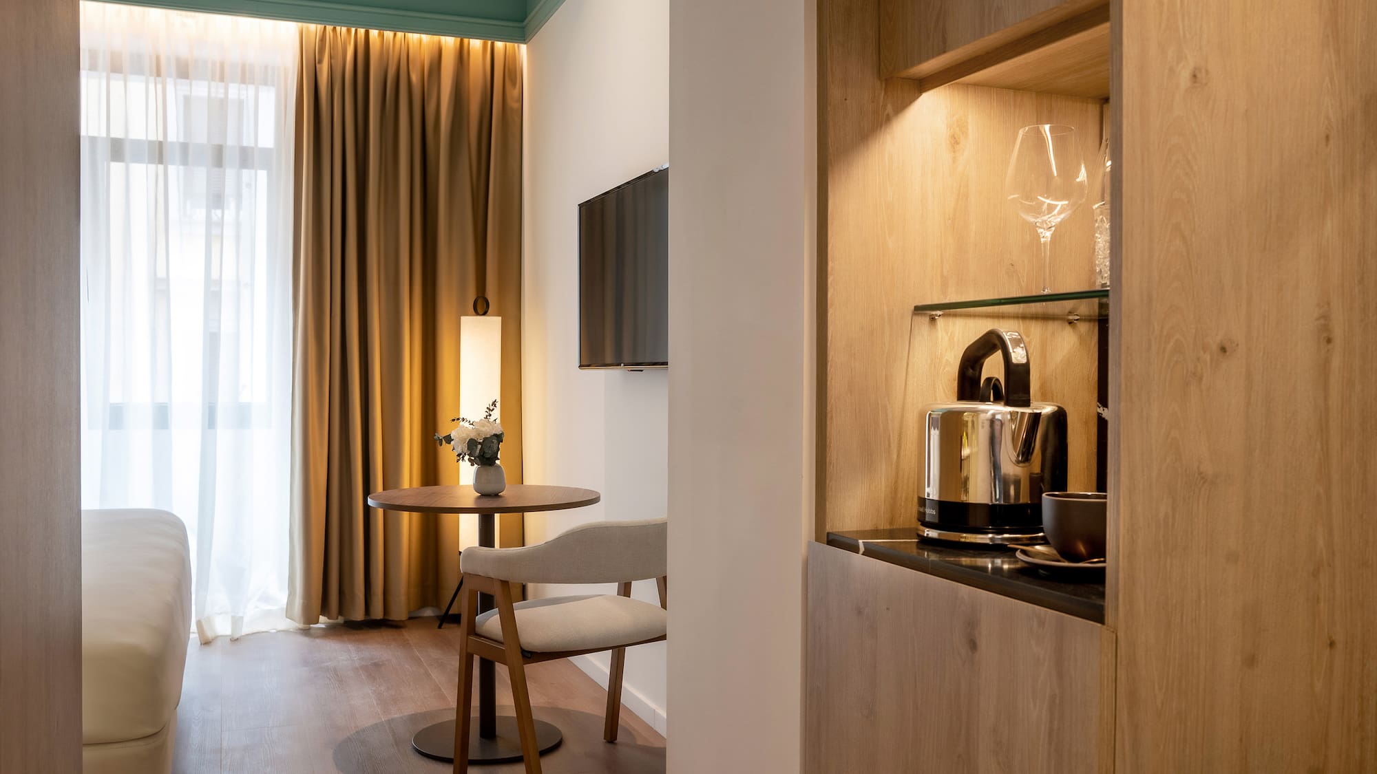 a room with a table and chairs and a television