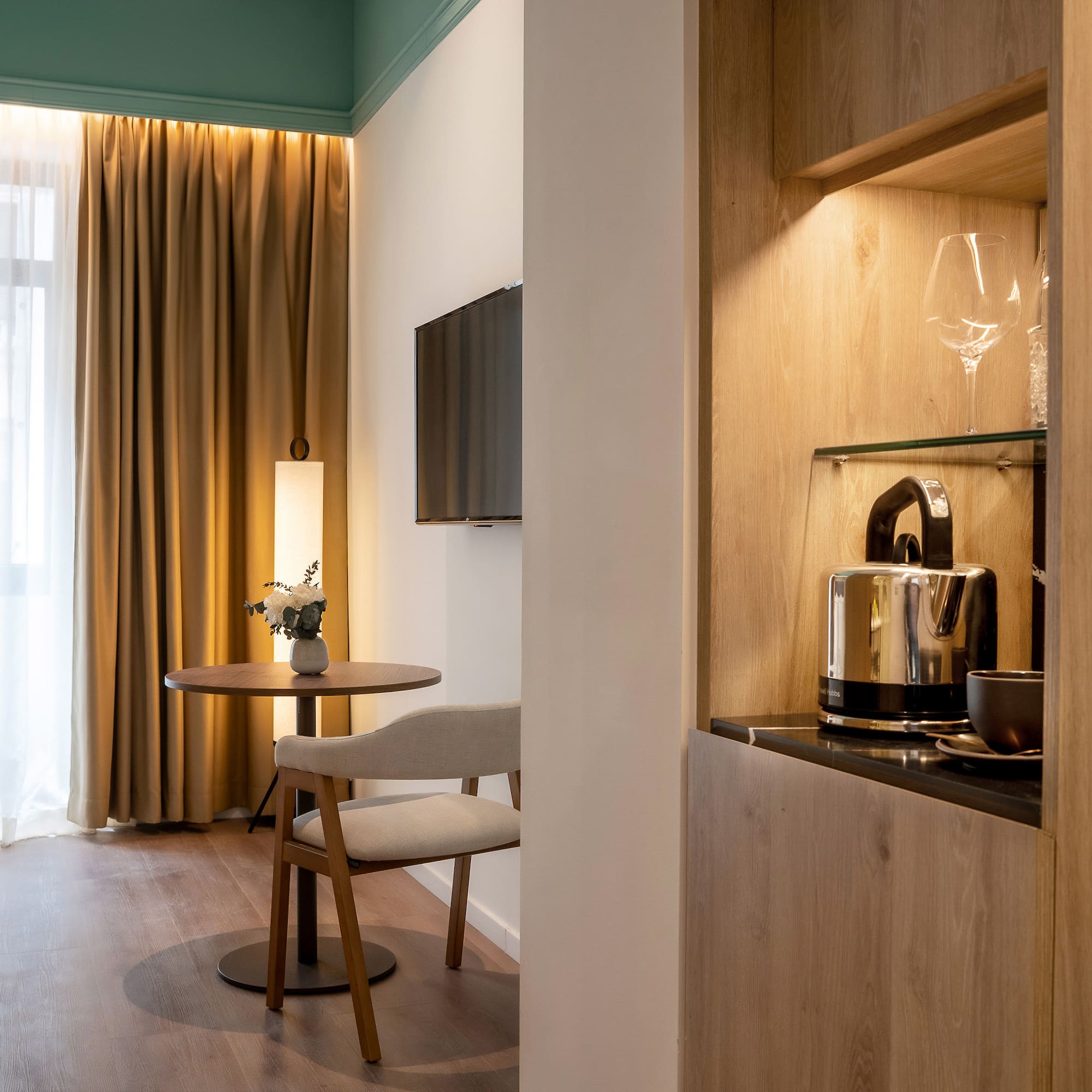 a room with a table and chairs and a television