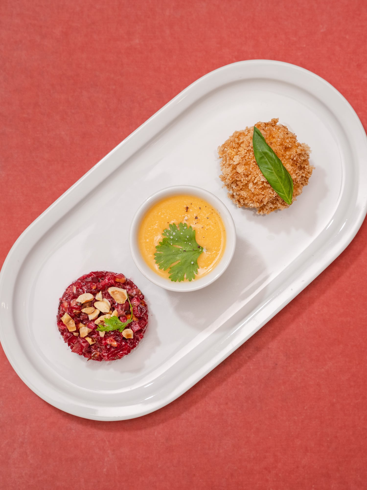 a plate of food on a red surface