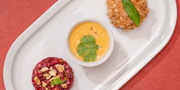 a plate of food on a red surface