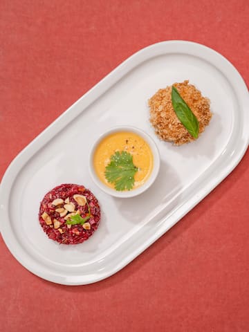 a plate of food on a red surface