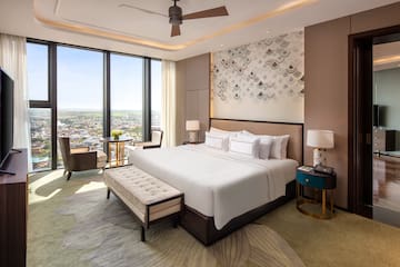 a room with a bed and a table and chairs