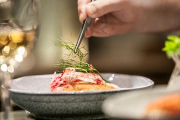 a person holding a piece of food