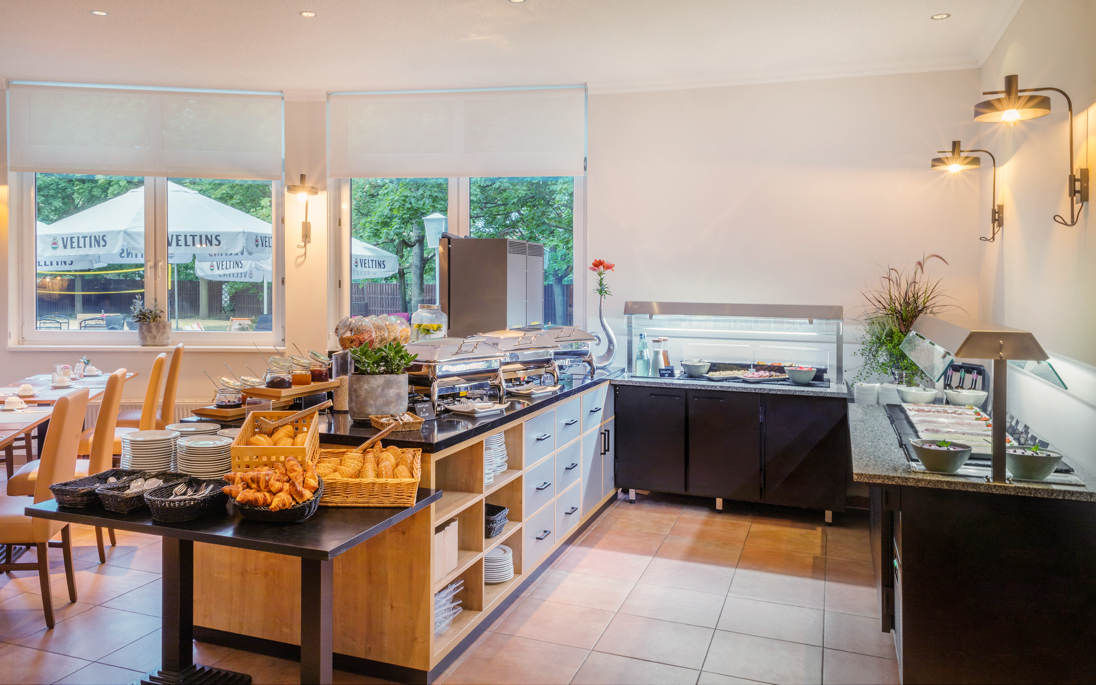 Hotel breakfast buffet with hot food, fresh pastries, and salad bar.