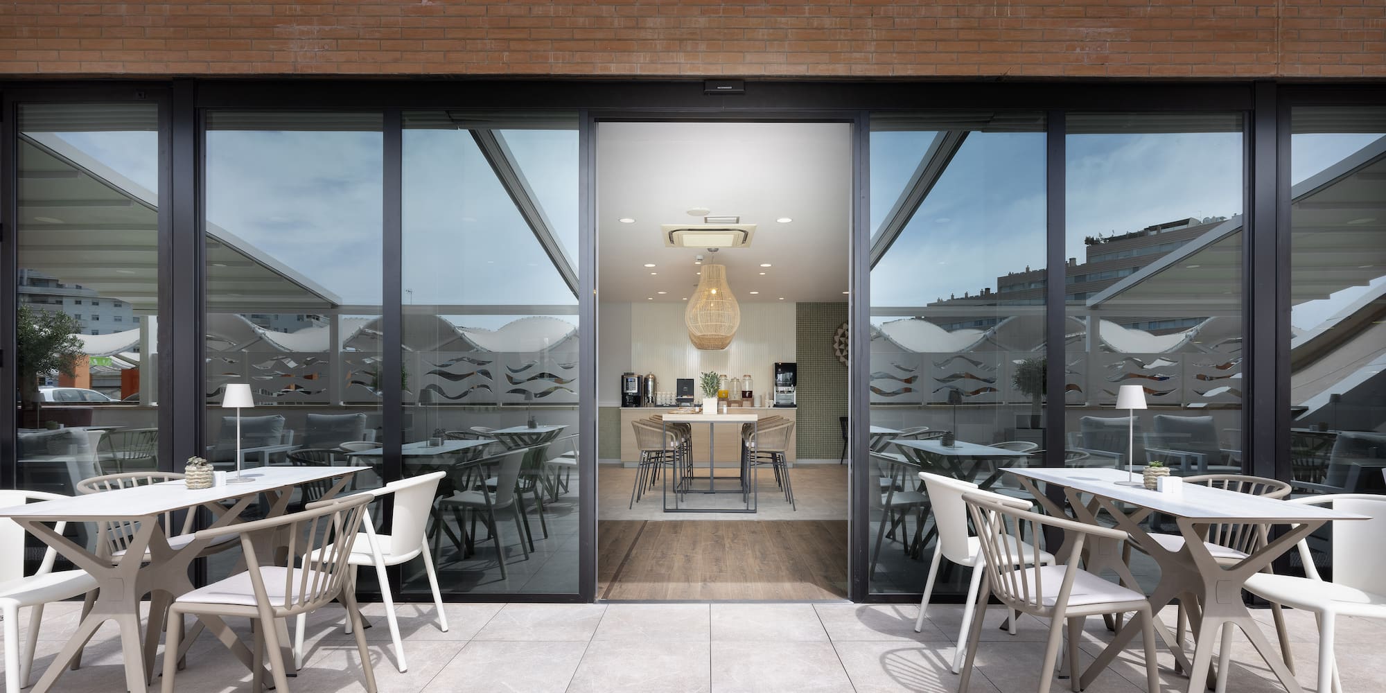 a patio with tables and chairs outside