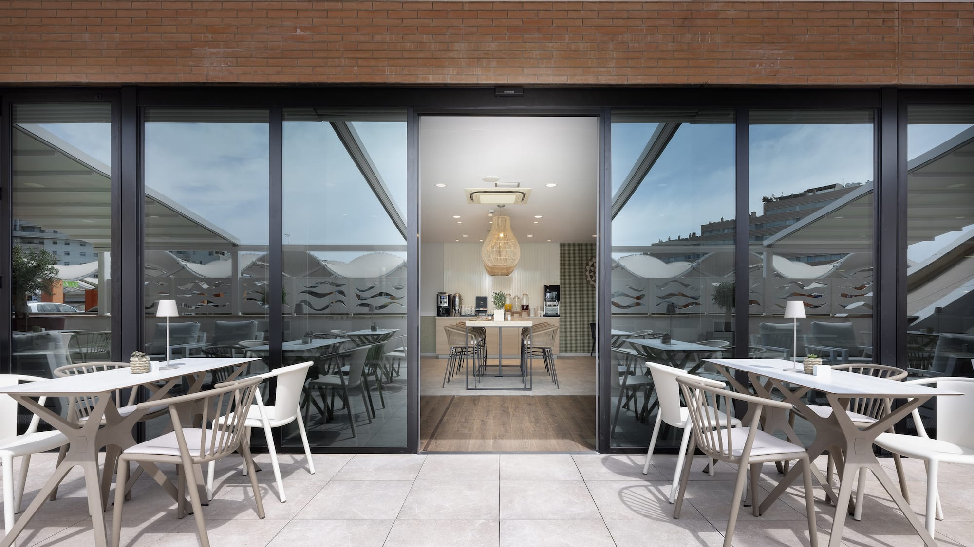 a patio with tables and chairs outside