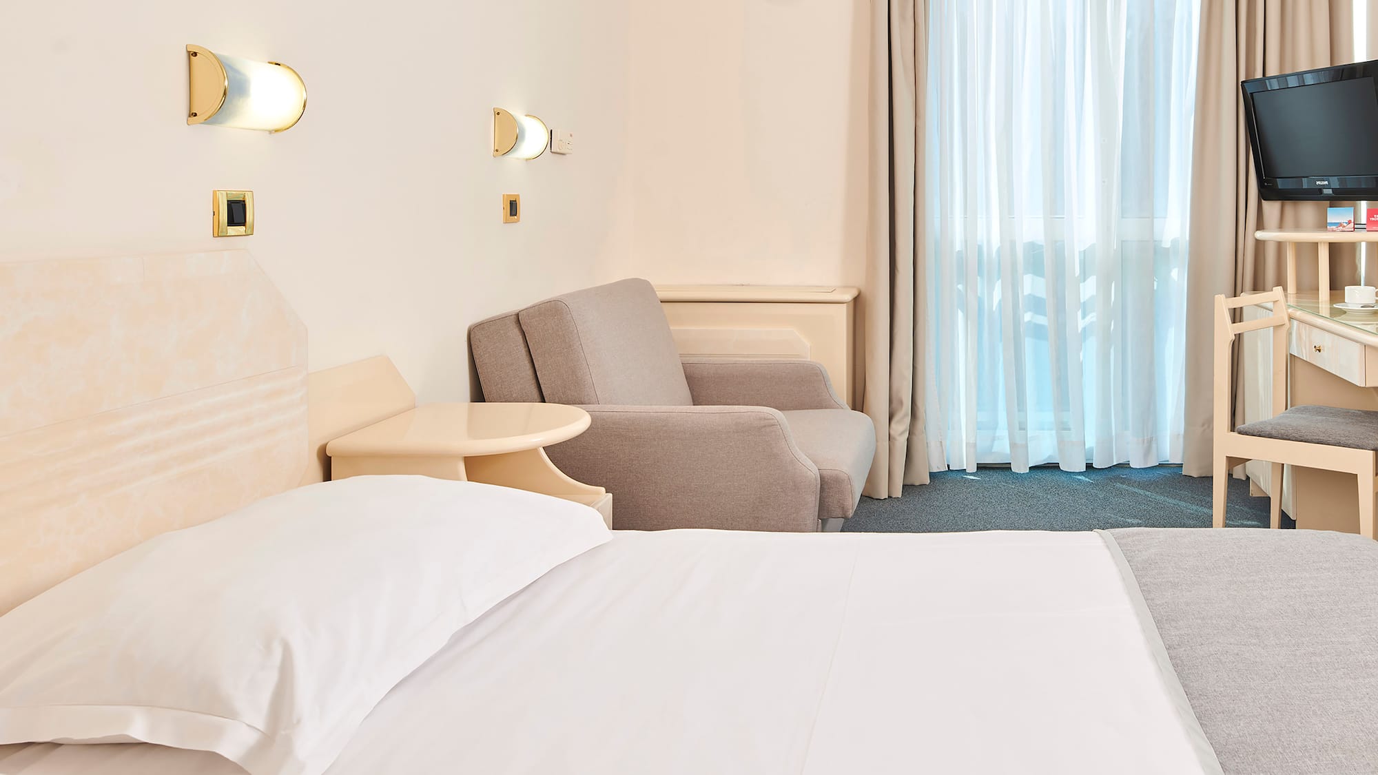 a bed and chair in a hotel room