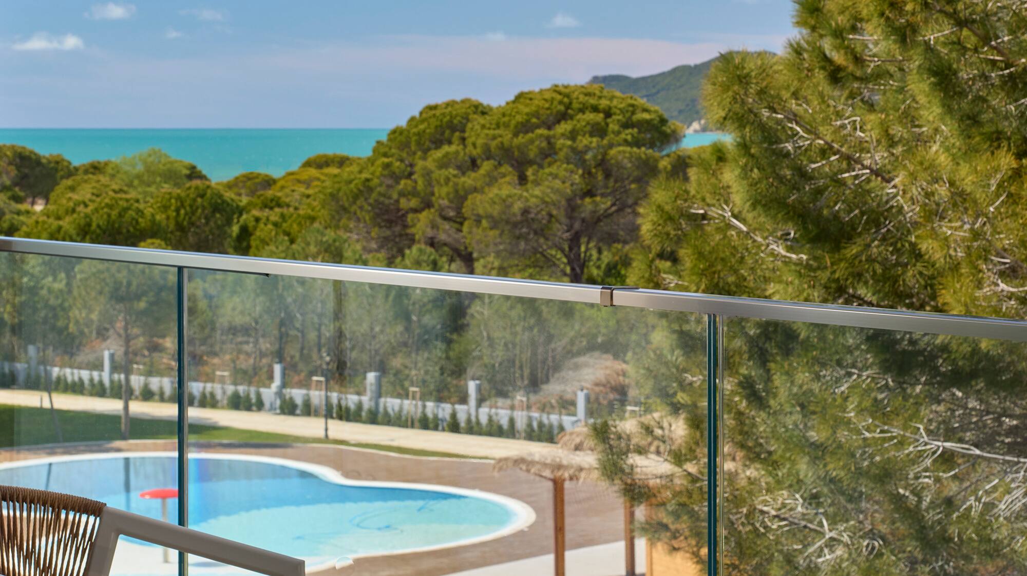 a pool and a chair on a balcony