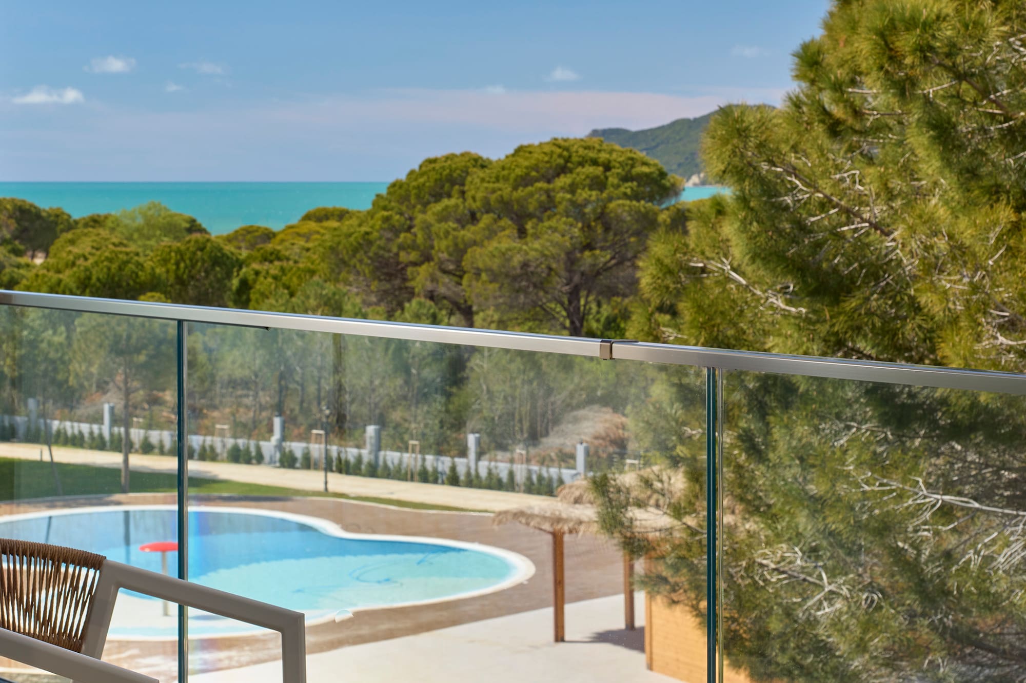 a pool and a chair on a balcony