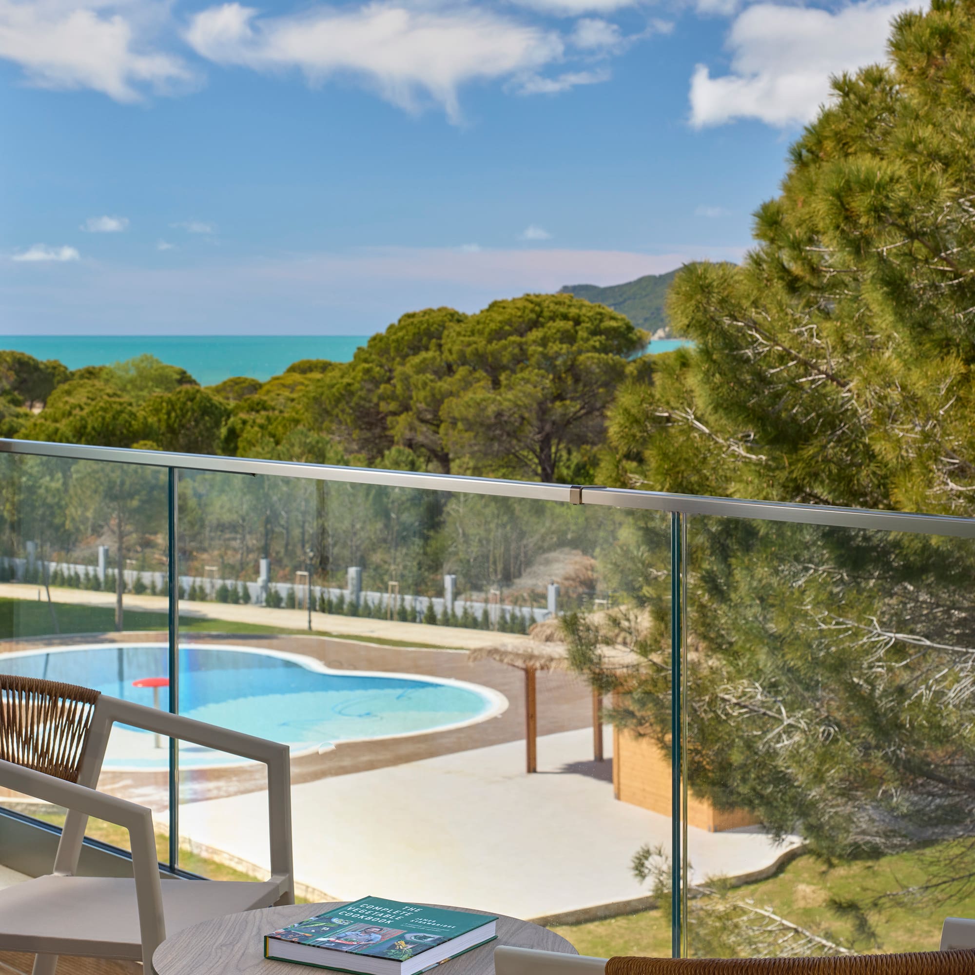 a pool and a chair on a balcony