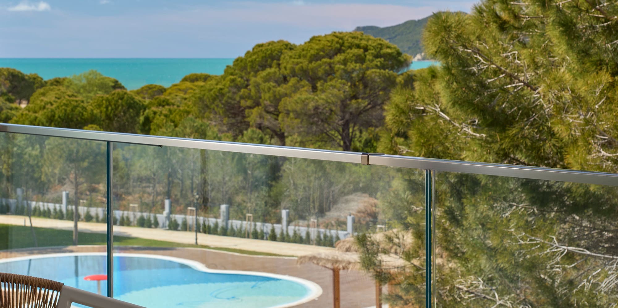 a pool and a chair on a balcony