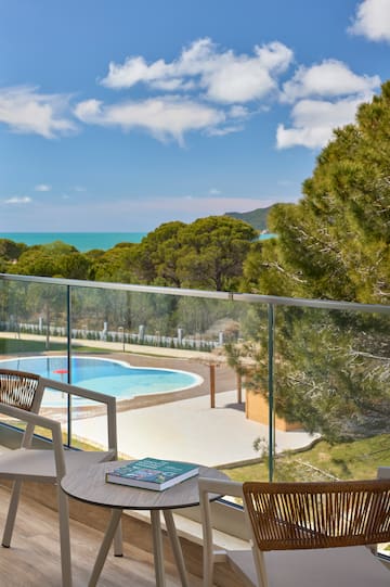 a pool and a chair on a balcony