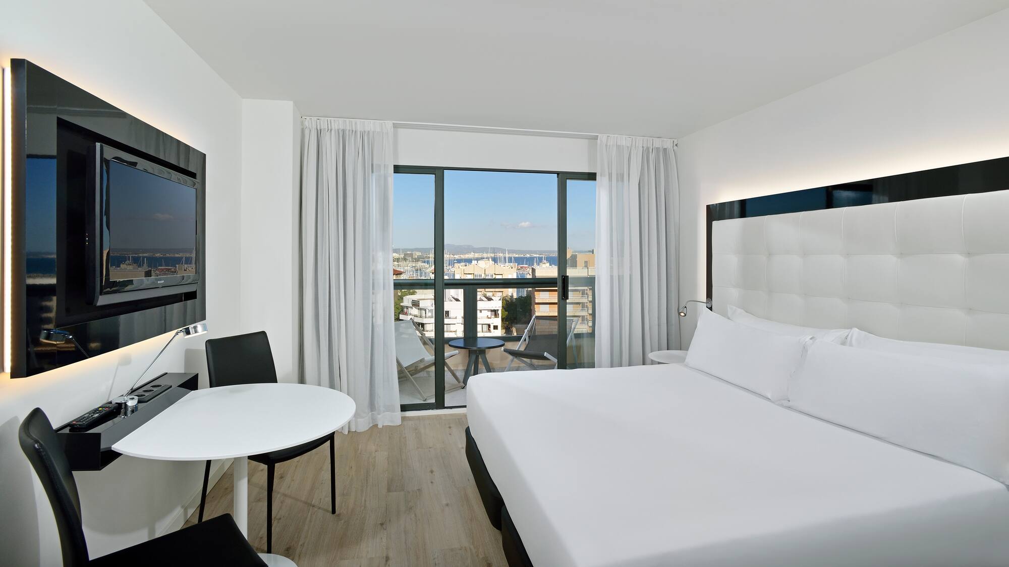 a room with a bed and a table and chairs