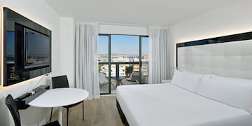 a room with a bed and a table and chairs