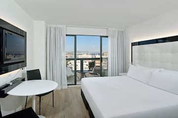 a room with a bed and a table and chairs