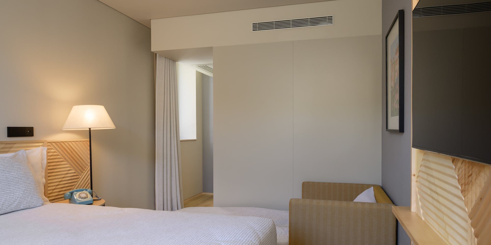 a bedroom with a bed and a lamp