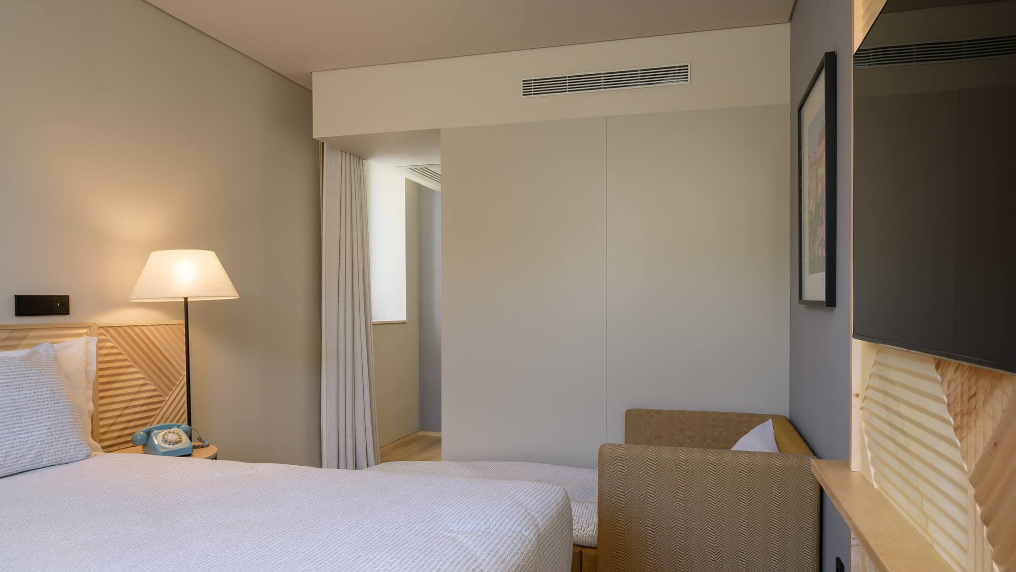 a bedroom with a bed and a lamp