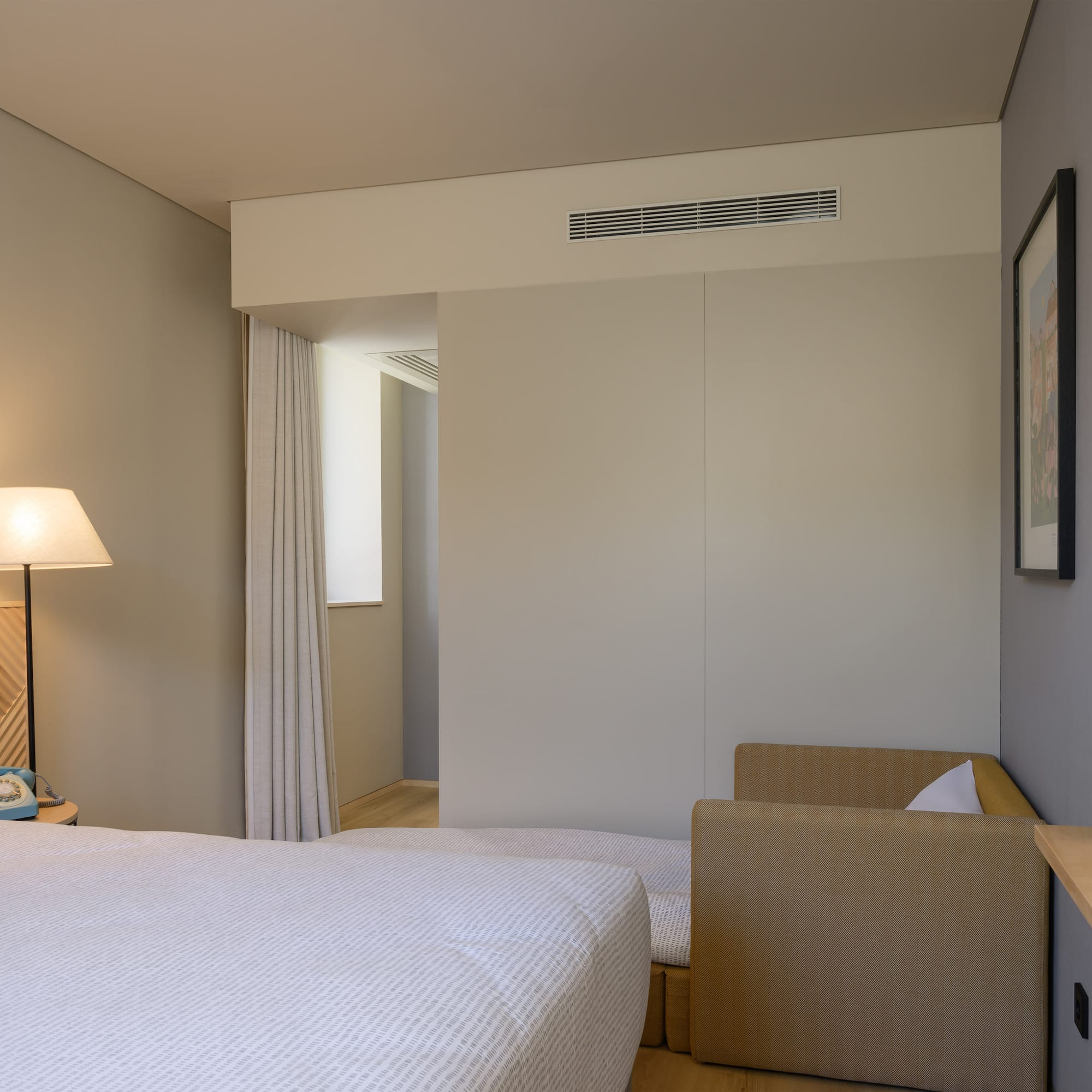 a bedroom with a bed and a lamp