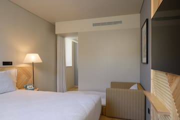 a bedroom with a bed and a lamp