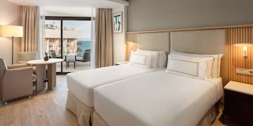 a room with two beds and a table